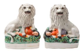 A pair of Staffordshire pottery figure groups: depicting the British lion seated over the prostrate