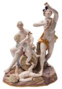 A large Meissen porcelain bacchanalian group: in the form of Bacchus holding aloft a bunch of