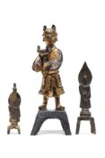 A Chinese gilt bronze figure: dressed in traditional costume holding a tripod censer in his arms,