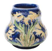 A Moorcroft Florian Ware vase: of squat gourd shaped form tubelined in the Cornflower pattern in