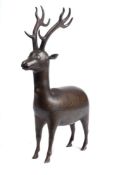 A 19th century Persian bronze and silver figure of a stag: with inlaid Arabic decoration of scrolls