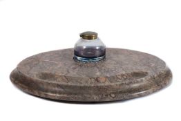A Torquay marble desk stand: of oval outline with curved pen tray and central clear glass inkwell,