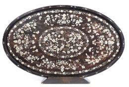 A Chinese hardwood and mother of pearl inlaid tray: of oval outline inlaid with butterflies amongst