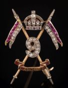 A ruby and diamond mounted '9th Royal Lancers' brooch: with calibre-cut rubies,