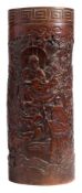 A 19th century Japanese bamboo brush pot: carved with figures of Immortals and gods in a wooded