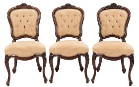 A set of four Victorian carved mahogany dining chairs:,