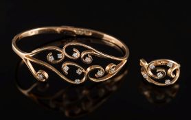 An 18ct rose gold and diamond mounted hinged bangle with matching ring: of openwork scroll design