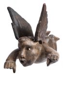 A German carved wood figure of an angel: with outstretched arms and wings, having inset glass eyes,