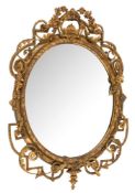 A 19th Century carved giltwood and gesso oval mirror:, of large size with open cartouche,
