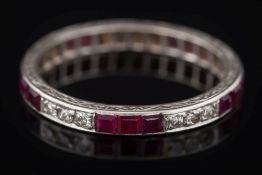A ruby and diamond eternity ring: with rows of calibre-cut rubies and circular-cut diamonds,