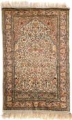 A Kashmir silk prayer rug:, the ivory mihrab with a design of birds, floral foliage and palmettes,