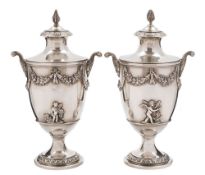 A pair of Edward VII silver urns and covers, maker C S Harris & Sons Ltd,