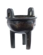 A Chinese bronze tripod censer of small size: The circular bowl with two loop handles,