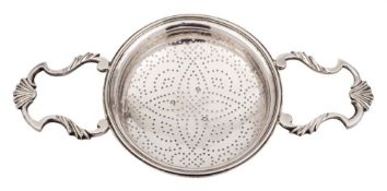 A late George II silver strainer, lacks maker's mark, London, 1759: with shaped loop handles, 21cm.