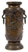 A Japanese bronze vase: decorated in low relief with exotic birds and butterflies amongst flowering