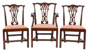 A set of twelve carved mahogany dining chairs in the Chippendale taste:,