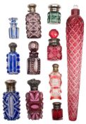 A group of eleven glass scent bottles: comprising coloured overlay, cut glass and silver and e.p.