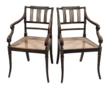 A pair of Regency ebonised beechwood and gilt wood and decorated elbow chairs:,