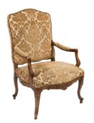 A French carved beechwood fauteuil in the Louis XIV taste:,