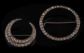 A graduated colourless paste-set crescent brooch: 36mm diameter and stamped '900' and an oval