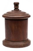 A 19th Century lignum vitae string box: of cylindrical form with domed screw cover, 20 cm.