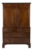 A George III mahogany linen press:, the upper part with a moulded cornice,
