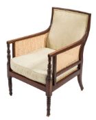 A Regency mahogany bergere armchair:, with curved upholstered panel back,