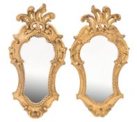 A pair of 19th Century Continental carved giltwood and gesso cartouche shaped wall mirrors:,
