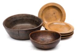 Two 19th century treen bowls and a set of four small shallow dishes: the two 14 and 20 cm;