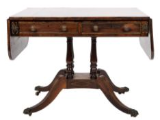 A Regency rosewood and brass inlaid sofa table,: bordered with lines,