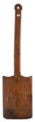 A 19th century treen bread peel: the handle with chamfered edges, possibly Welsh, 60 x 15 cm.