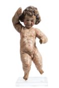 A 17th century Italian carved wood and polychrome decorated figure of a cherub: mounted on a