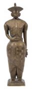A late 19th century Burmese brass figure: standing in traditional costume wearing a four cornered