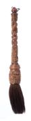A Chinese carved wood calligraphy brush: the handle carved with an entwined dragon chasing a pearl