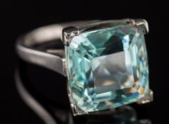 An 18ct white gold and aquamarine single-stone ring: the cushion-shape aquamarine 13.