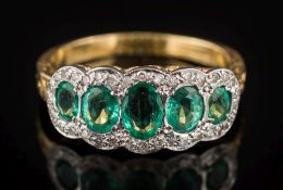 An 18ct yellow gold, emerald and diamond ring: with graduated,
