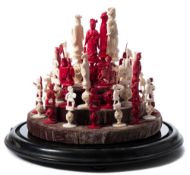 A late 19th century Cantonese carved ivory mandarin pattern chess set: one side red stained,