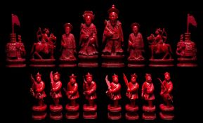 A Canton carved ivory mandarin pattern chess set: one side stained red, the other side left natural,