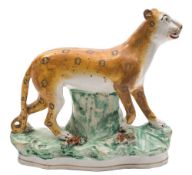 A Staffordshire pottery model of a leopard: on raised tree stump base, probably Thomas Parr,