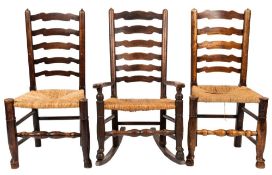 A harlequin set of six early 19th Century elm and ash ladderback dining chairs:,