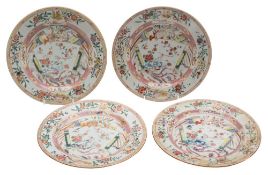 A set of four Chinese famille rose plates: each painted with a scroll shaped panel, a phoenix,