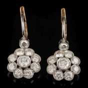A pair of diamond mounted circular cluster drop earrings: each with a cluster of circular