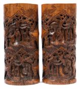 A pair of Chinese carved bamboo brush pots: decorated with figures in a pagoda landscape, unsigned,