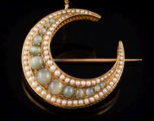 A 19th century seed-pearl and chrysoberyl cat's-eye mounted crescent brooch: with attached safety