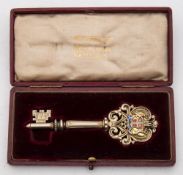 A George V silver-gilt and enamel presentation key, maker Vaughton & Sons, Birmingham,