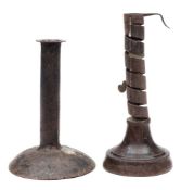 An 18th Century Scottish fruitwood and iron candlestick and a plain metal candlestick: the first