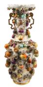 A large Jacob Petit fruit encrusted vase: of baluster form with gilt fret and scroll handles,