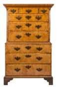 An early 18th Century walnut and crossbanded tallboy:, the upper part with a moulded dentil cornice,