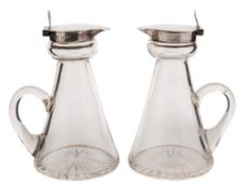 A pair of George V clear glass and sliver mounted whisky noggins,