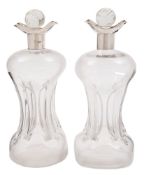 A pair of late Victorian silver mounted clear glass decanters, maker William Gibson & John Landman,